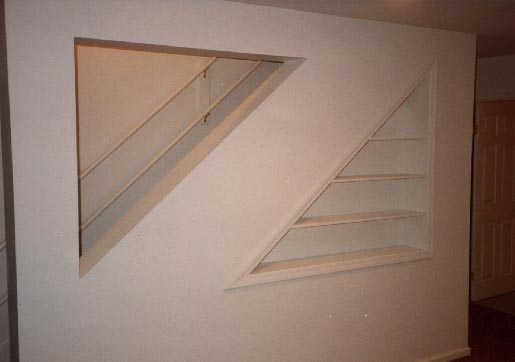 Finished built-in bookcase under stairs to basement